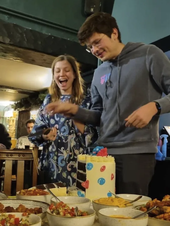 Cutting a gender reveal cake together in 2022